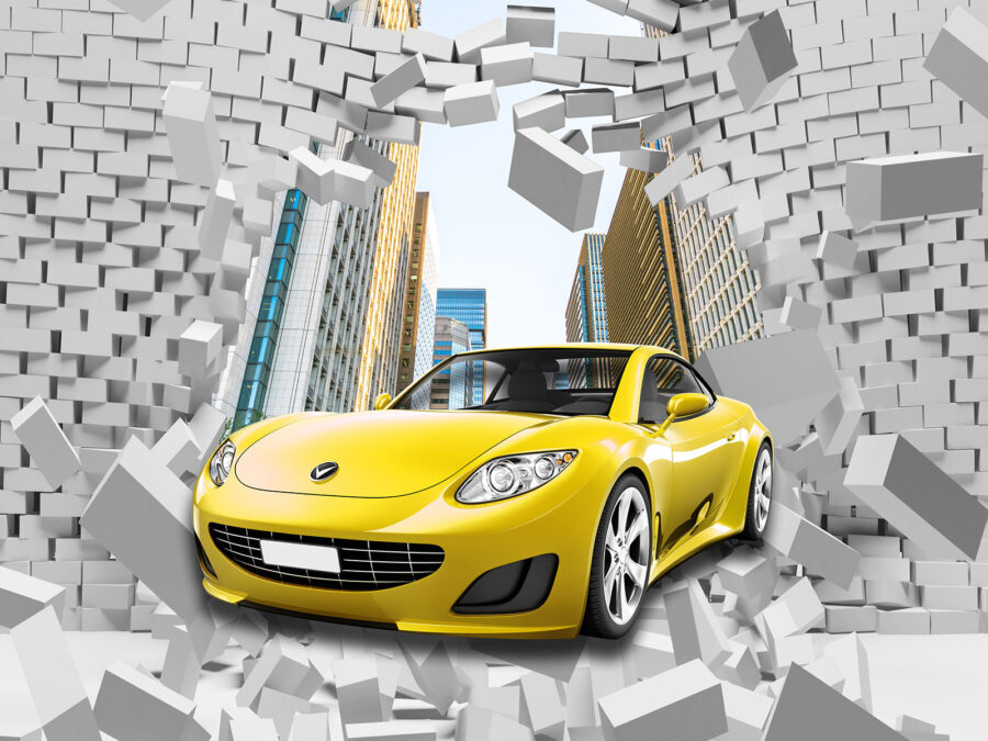 Carro amarelo num muro de tijolos