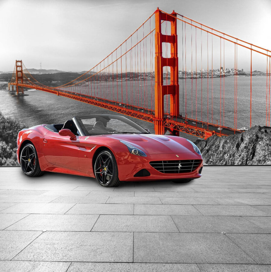 Carro desportivo vermelho numa estrada com uma ponte ao fundo