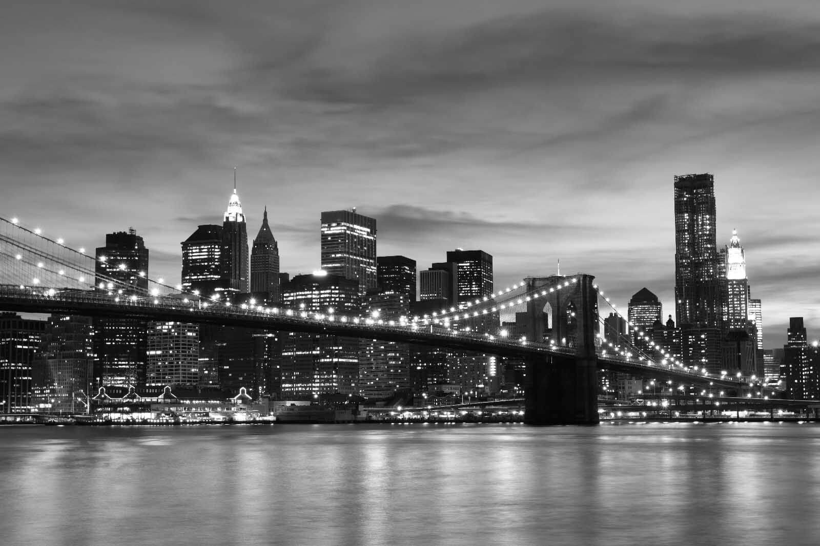 Bridge over water with city skyline in the background Bridge over water with city skyline in the background