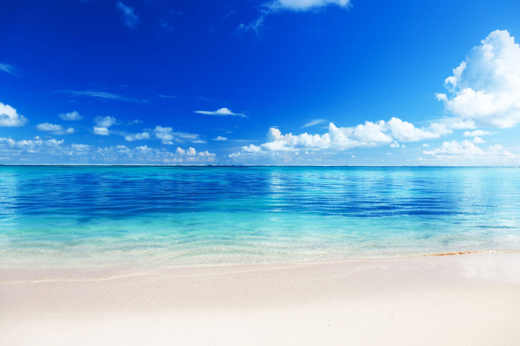 Beach with blue water and clouds Beach with blue water and clouds