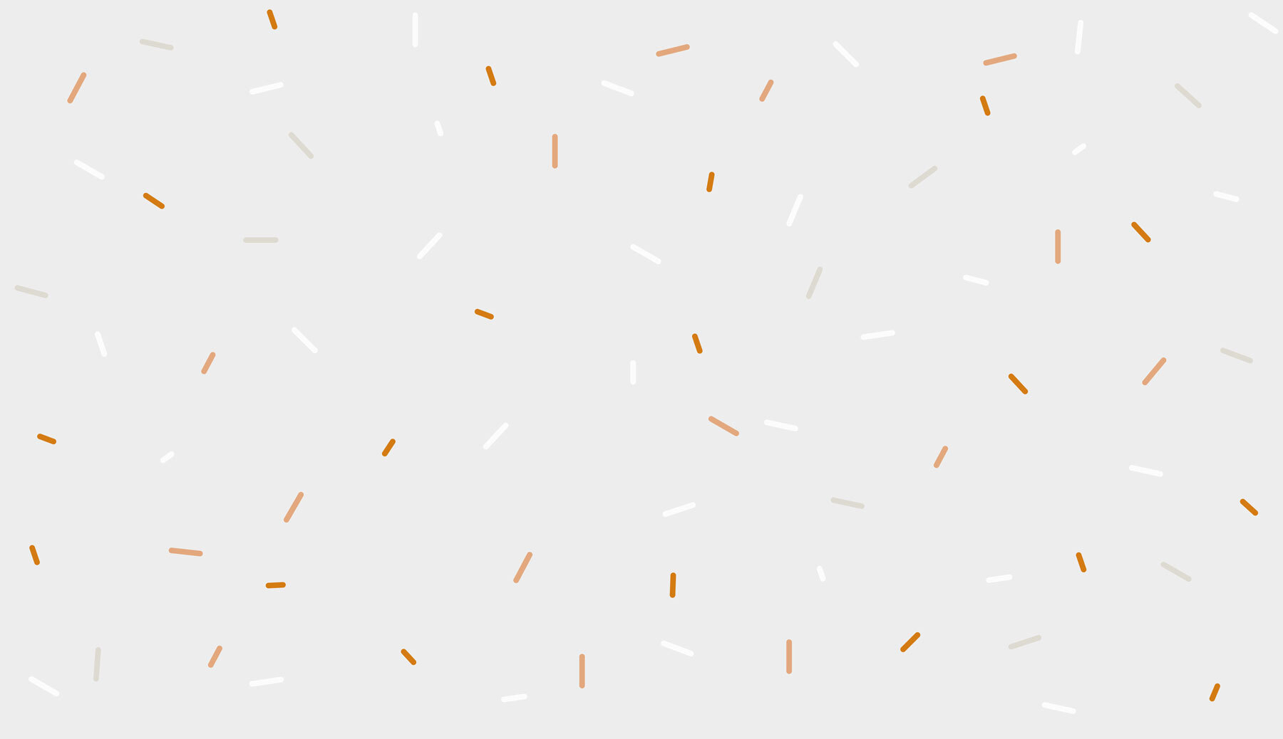 A white and orange sprinkles on a gray background A white and orange sprinkles on a gray background