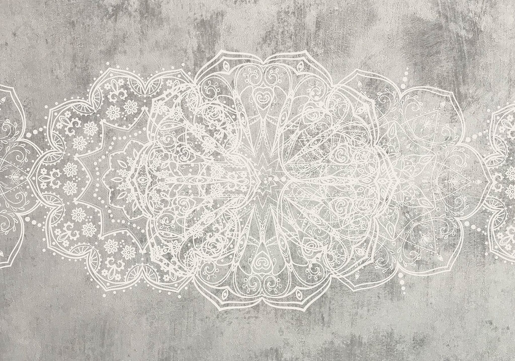 White ornate design on a grey surface
