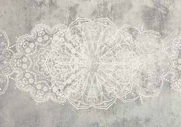 White ornate design on a grey surface