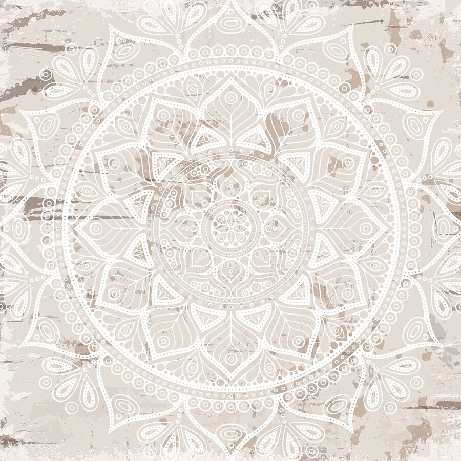Mandala branca sobre uma superfície castanha