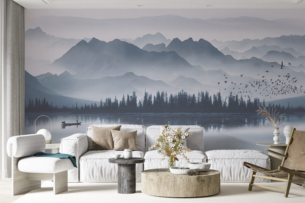 Person in a boat on a lake with mountains in the background Person in a boat on a lake with mountains in the background