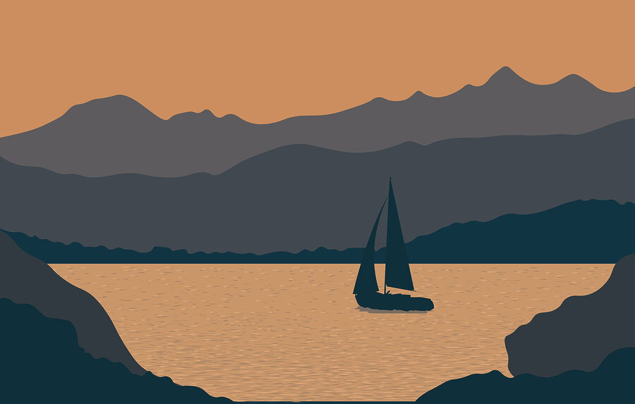 Barco à vela na água com montanhas ao fundo