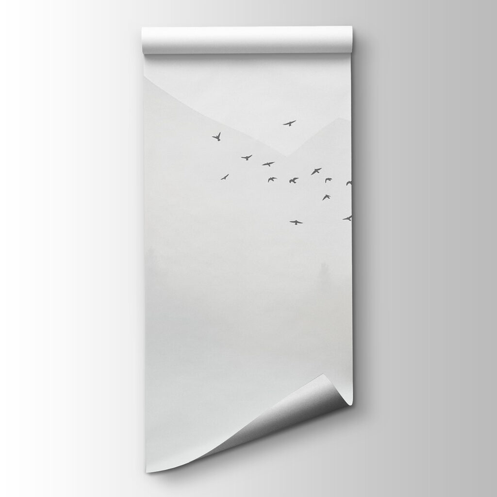 Birds flying over a foggy forest